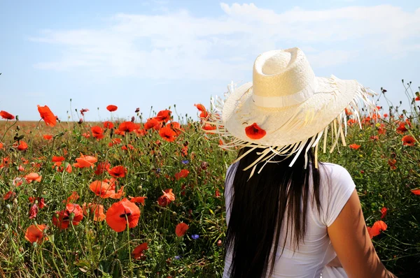 Young beautiful woman in poppy flowers — Stock Photo, Image