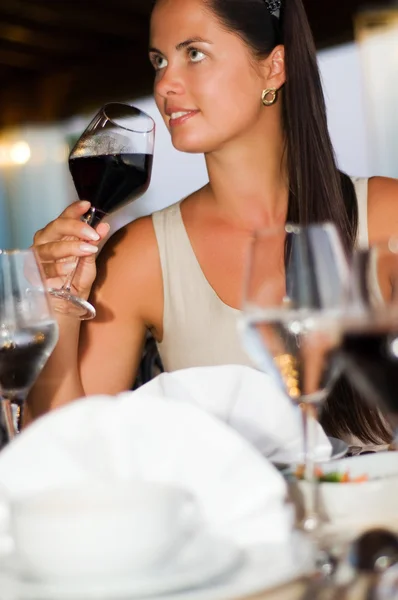 Красивая женщина пробует красное вино — стоковое фото