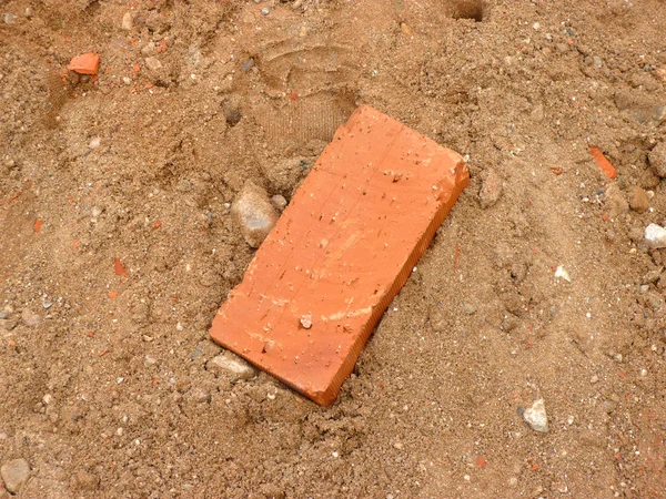 One brick on sand — Stock Photo, Image