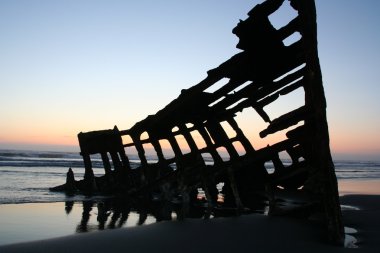 Shipwreck at night fall on Oregon coast clipart