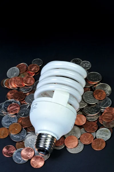 Fluorescent light bulb and money. — Stock Photo, Image