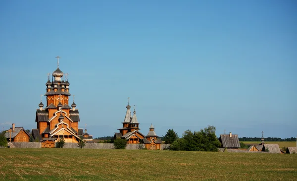 Village with a wooden church — Stock Photo, Image