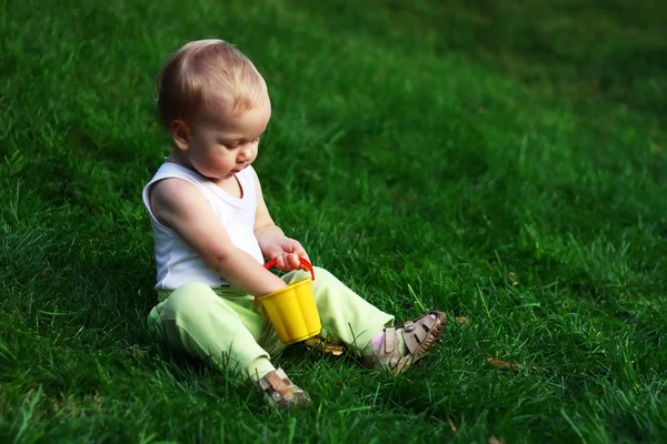 Niño pequeño en una hierba verde — Foto de Stock