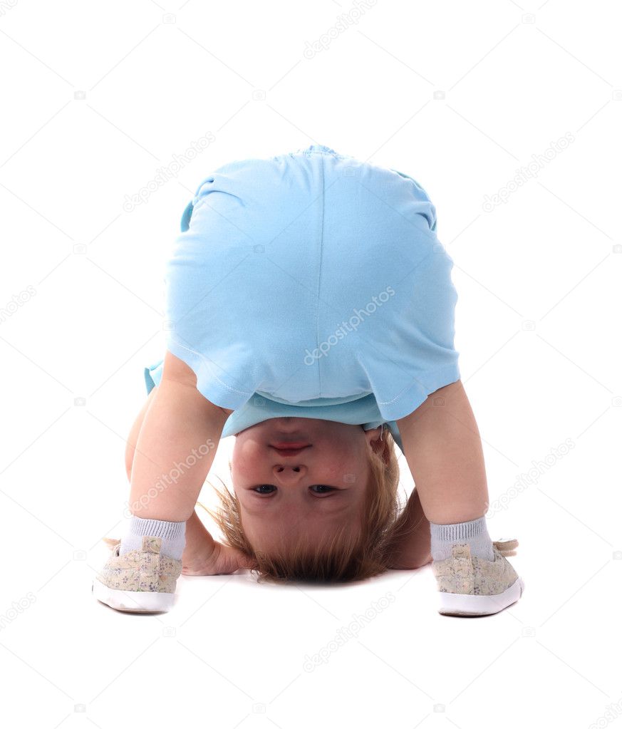 Little boy stands upside-down