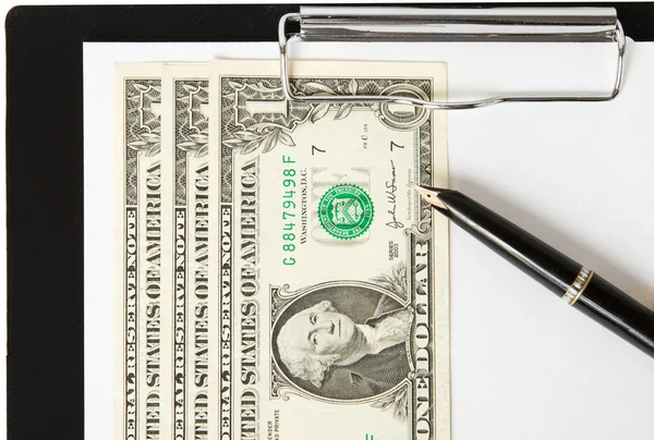 Dollars, pen and paper sheet on binder — Stock Photo, Image