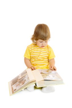 Small girl browsing an family album clipart