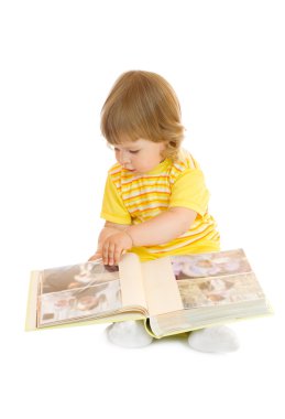 Small girl browsing an family album clipart