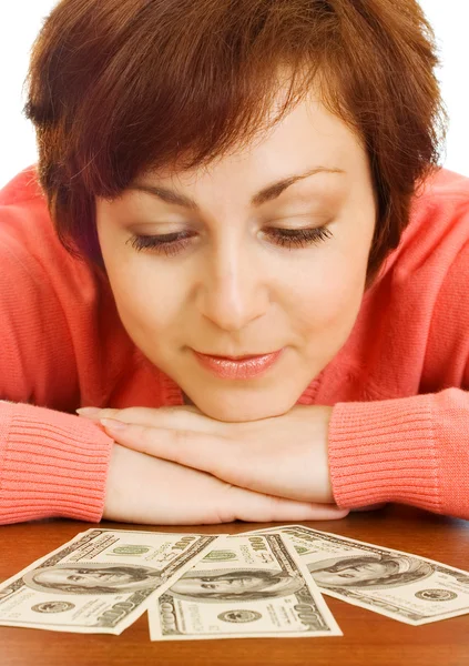 Doubting young woman with money — Stock Photo, Image