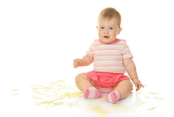 Sitting small baby with yellow petals — Stock Photo, Image