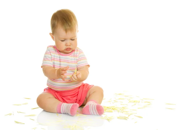 Sitzendes kleines Baby mit gelben Blütenblättern # 5 — Stockfoto