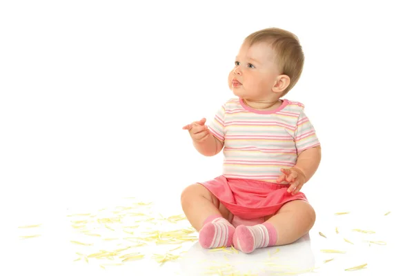 Małe dziecko siedzi z płatki żółty — Zdjęcie stockowe