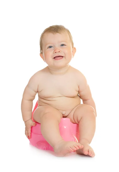 Small smiling baby on pink chamberpot — Stock Photo, Image