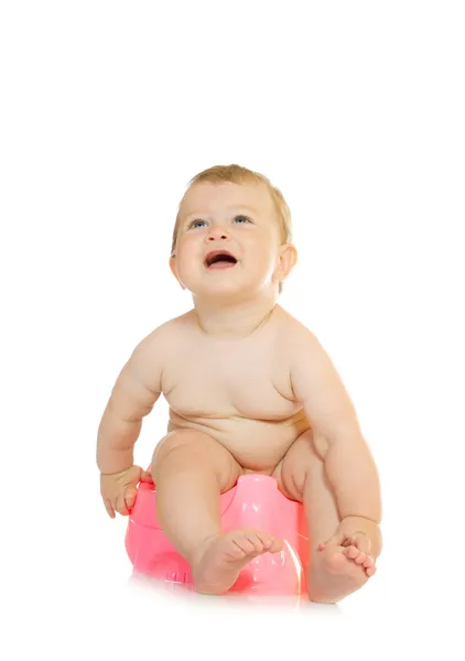 Small smiling baby on pink chamber-pot i — Stockfoto