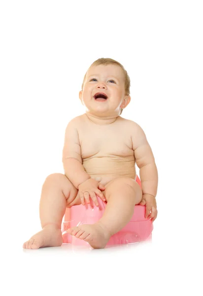 Małe dziecko uśmiechający się na różowy-garnek — Zdjęcie stockowe