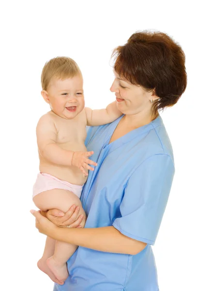 Доктор держит маленького улыбающегося ребенка в изоляции — стоковое фото
