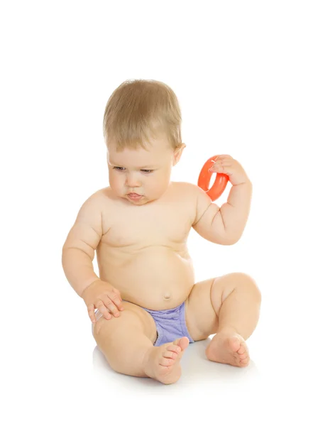 Small sitting baby with toy isolated — Stock Photo, Image