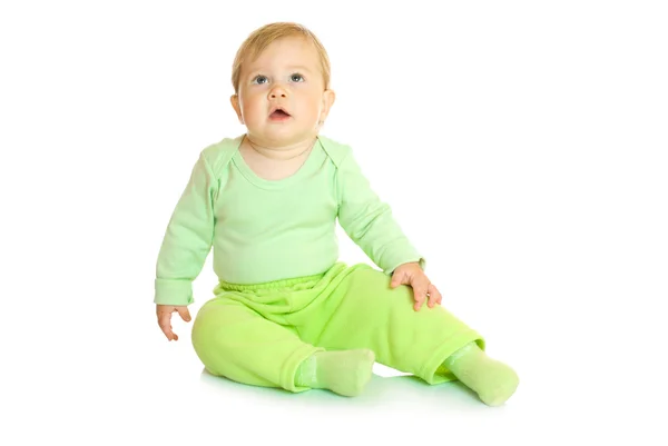Pequeño bebé sentado en verde aislado —  Fotos de Stock