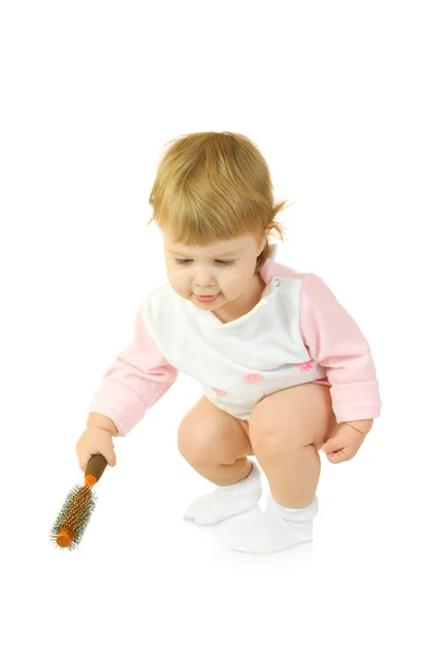 Bebé pequeño en vestido rosa con cepillo — Foto de Stock
