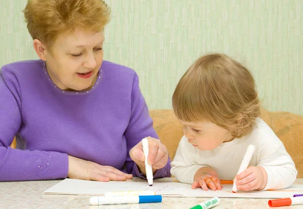 Drawing baby with her grandma at home — Stock Photo, Image