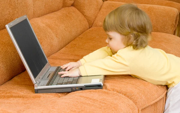 Small baby with grey laptop at home — Stock Photo, Image