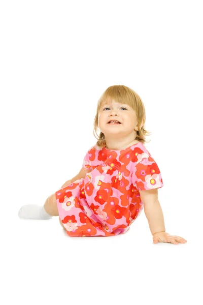 分離された赤いドレスで小さなシッティング赤ちゃん — ストック写真