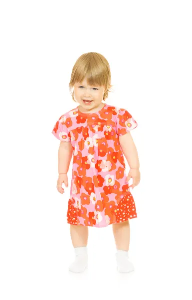 Kleine glimlachende baby in rode jurk — Stockfoto