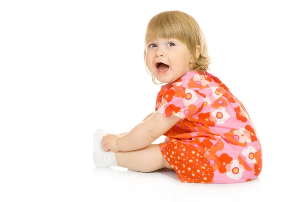 Kleines lächelndes Baby im roten Kleid isoliert — Stockfoto