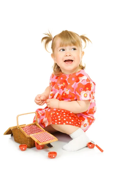 Pequeño bebé sonriente en vestido rojo con juguete — Foto de Stock