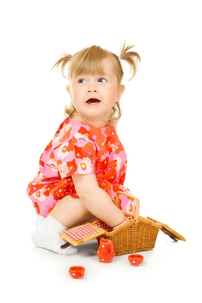 Piccolo bambino sorridente in abito rosso con giocattolo — Foto Stock
