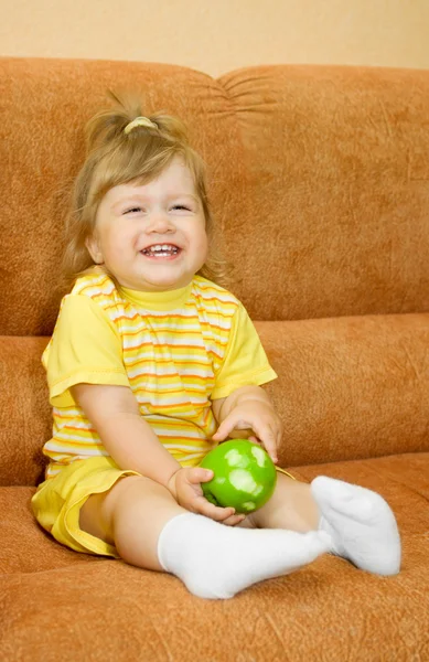 Χαμογελαστό κορίτσι σε κίτρινο με το πράσινο μήλο — Φωτογραφία Αρχείου