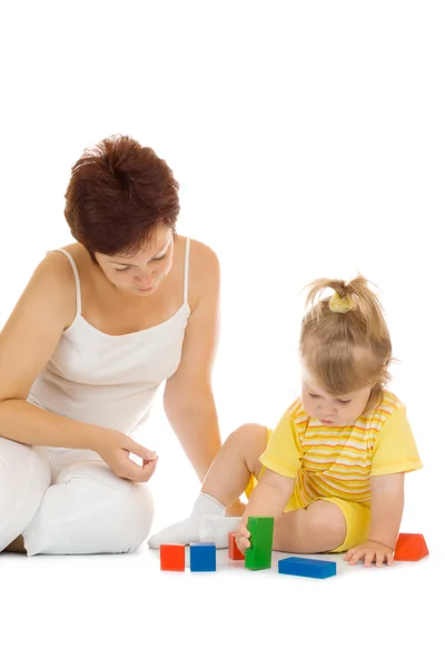 Small girl build pyramid with mother — Stock Photo, Image
