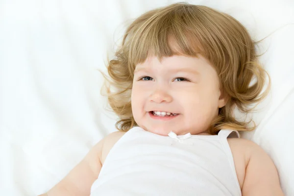 Little girl on a bed — Stock Photo, Image