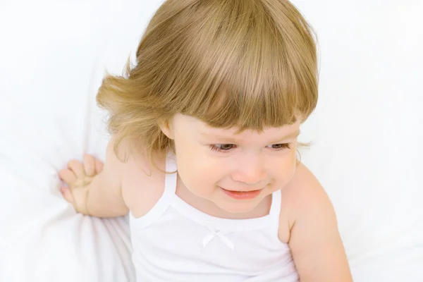 Smiling girl in a bed — Stock Photo, Image
