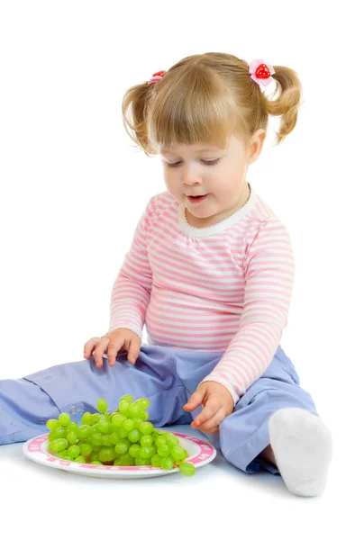 Little girl with grapes — Stock Photo, Image