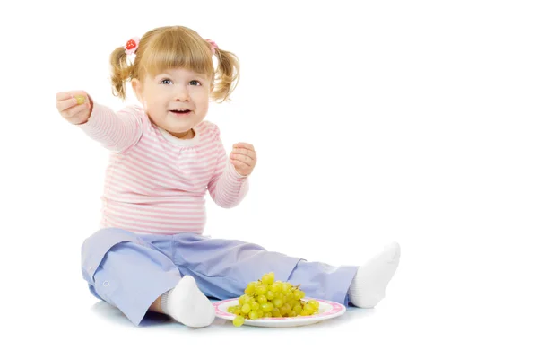 Little girl with grapes — Stock Photo, Image