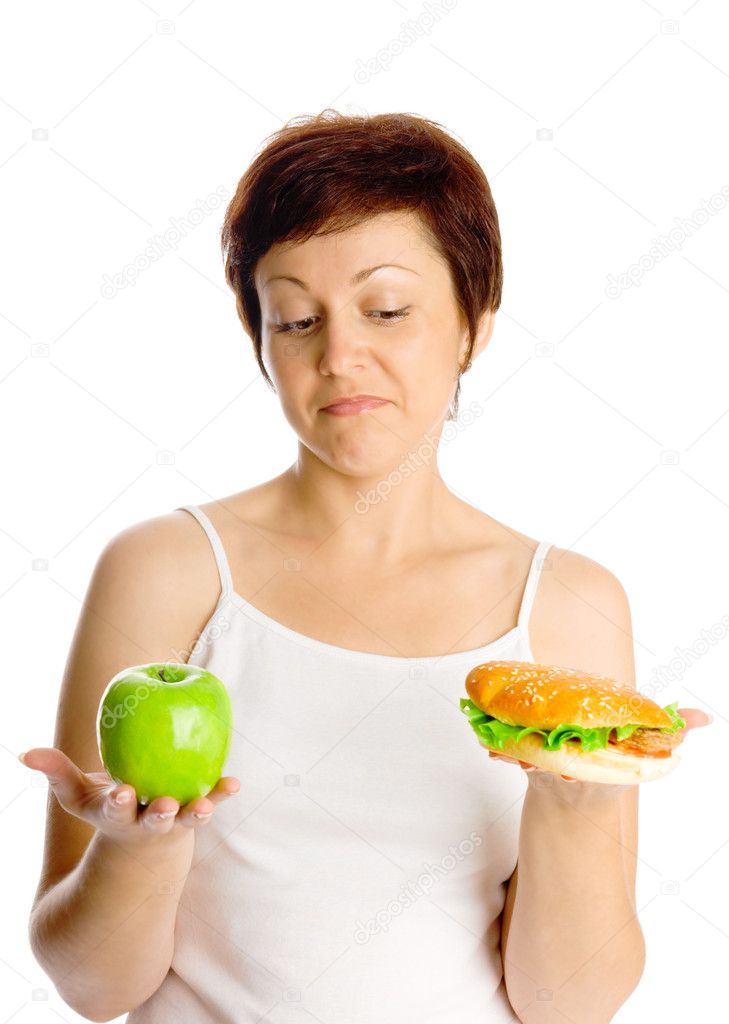 Young woman with hamburger and apple