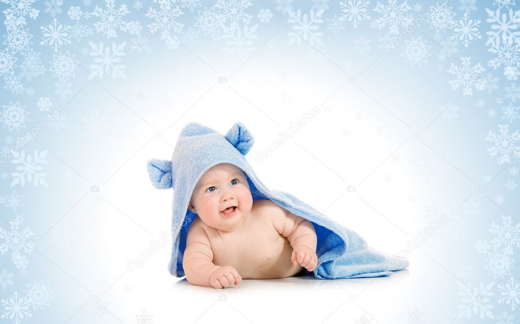 Small smiling baby with on snowy backgro