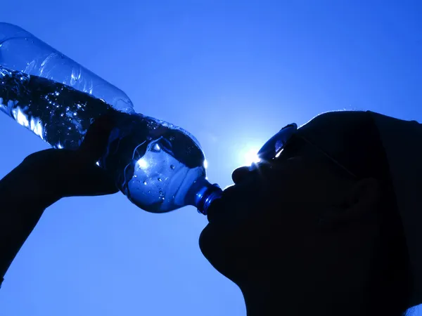 Woman drinking water in the sun — Stock Photo, Image