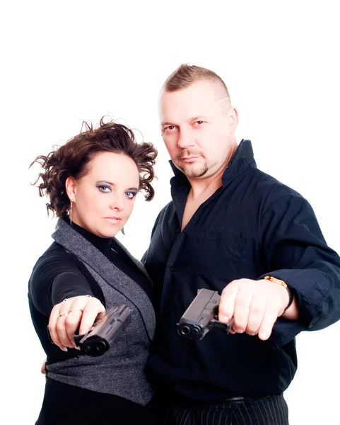Couple holding guns over white backgroun — Stock fotografie
