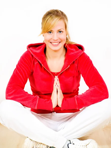 Smiling blond woman exercising yoga Stock Image