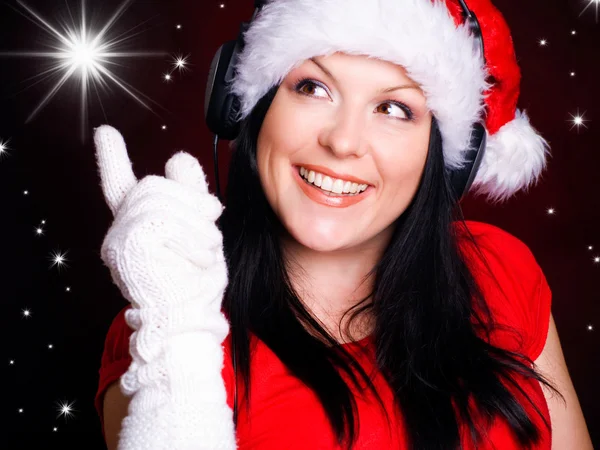 Mulher de Natal com fones de ouvido — Fotografia de Stock