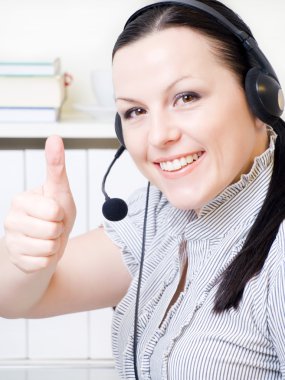 Woman with headphones in office clipart