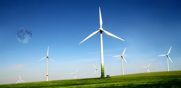 Wind turbines farm with high moon — Stock Photo, Image
