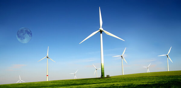 Wind turbines farm with high moon