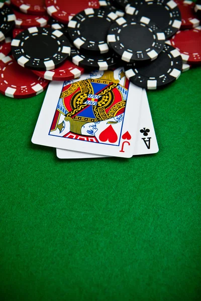 Black and red poker chips in the background. — Stock Photo, Image