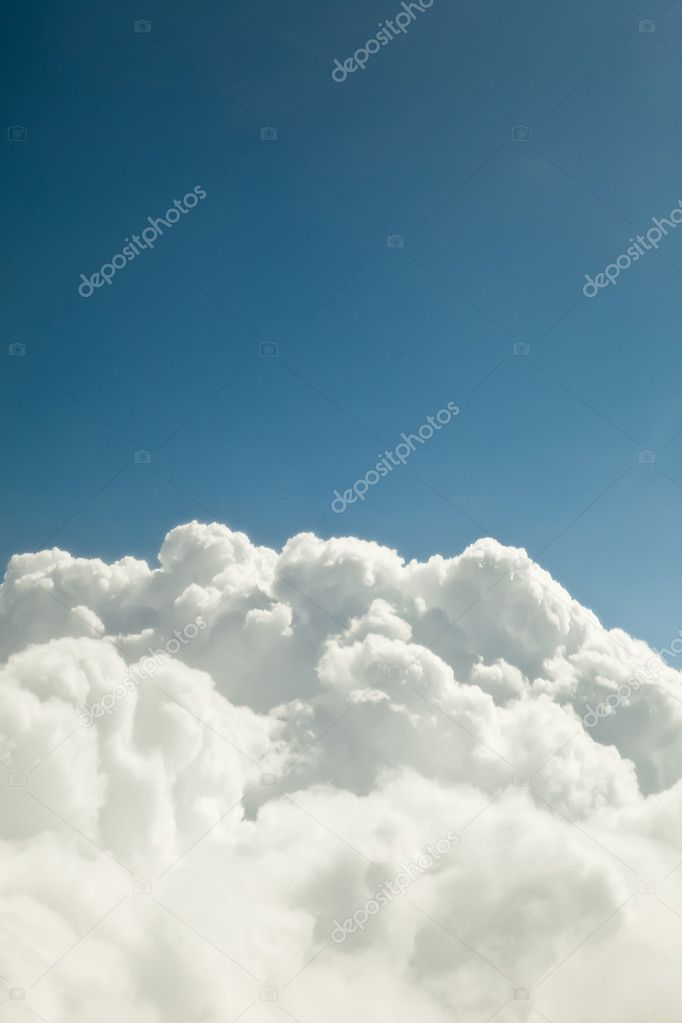 Blue sky with white clouds - looks like a mounta