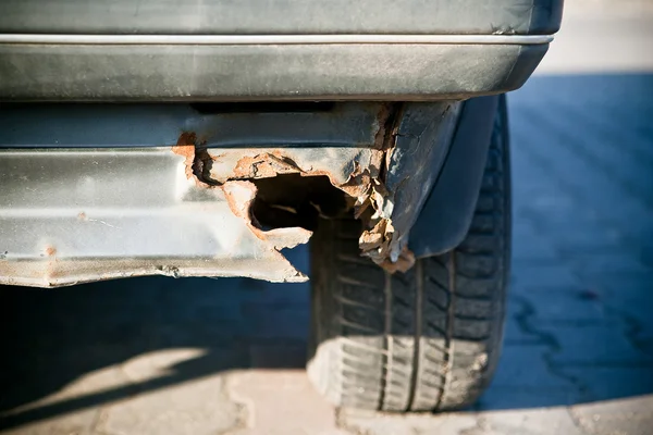 stock image Old rusted car in junk yard - close-up to wheel