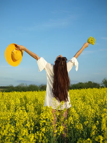 stock image Beautiful woman on field in bloom