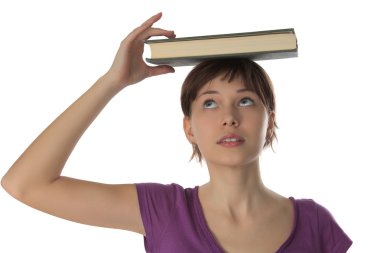 Beautiful girl holds book on a head clipart