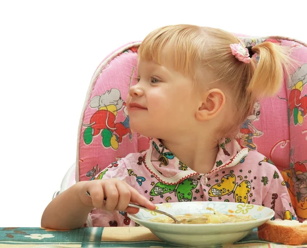 金发的小女孩吃 免版税图库照片